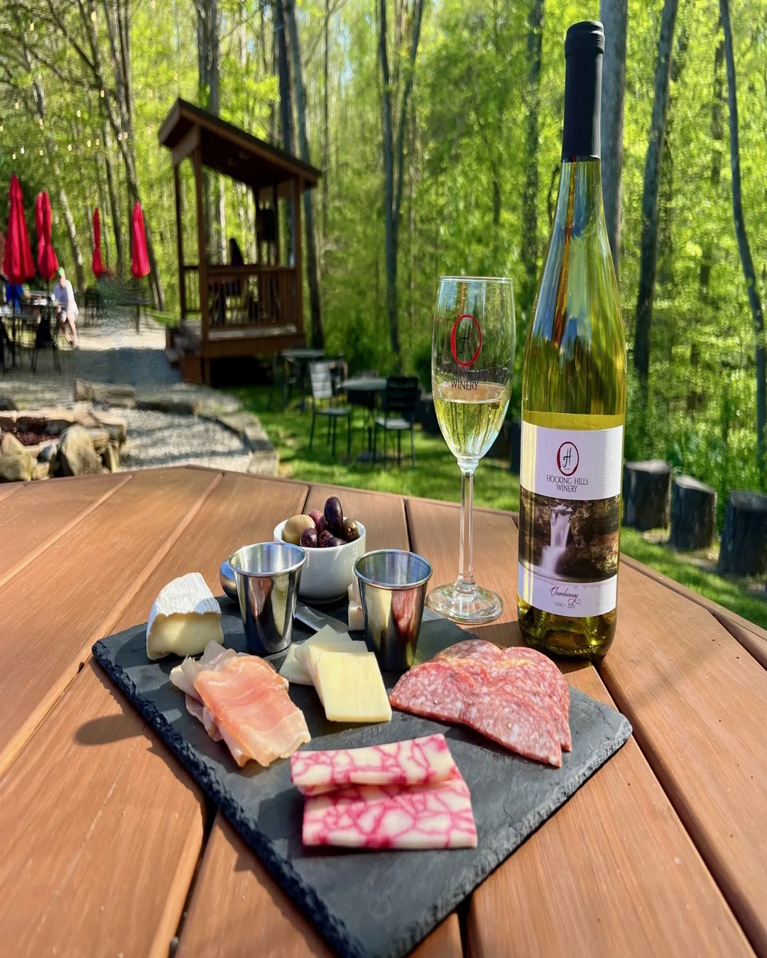 Wine and charcuterie board at an outdoor table